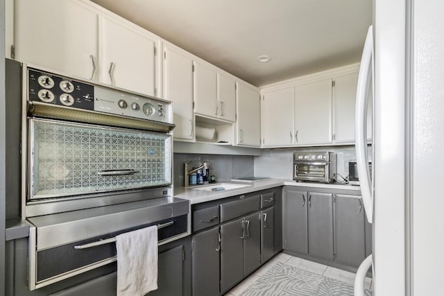 3500 S Ocean Blvd Unit 308, South Palm Beach, FL 33480 - kitchen with freestanding refrigerator, a sink, oven, and light countertops