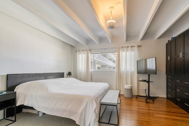 3500 S Ocean Blvd Unit 308, South Palm Beach, FL 33480 - bedroom with beam ceiling and wood finished floors