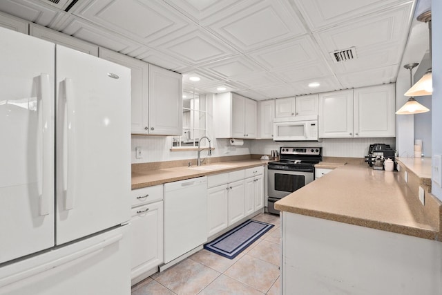 2560 50th Ave, Vero Beach, FL 32966 - kitchen featuring white appliances, a sink, recessed lighting, white cabinetry, and light tile patterned floors