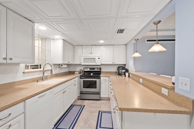 2560 50th Ave, Vero Beach, FL 32966 - kitchen with white appliances, a sink, white cabinetry, recessed lighting, and an ornate ceiling