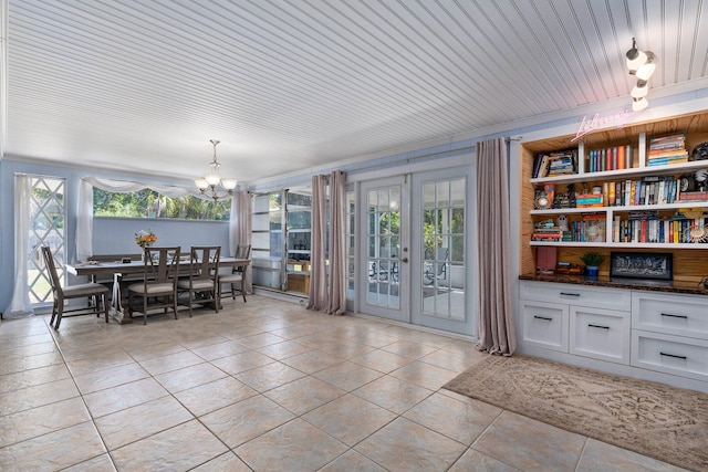 2560 50th Ave, Vero Beach, FL 32966 - dining space with french doors, a chandelier, light tile patterned floors, and healthy amount of natural light