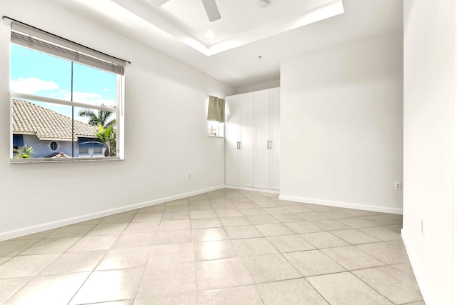 1246 Via De Fossi, Boynton Beach, FL 33426 - empty room with ceiling fan, baseboards, light tile patterned flooring, recessed lighting, and a tray ceiling