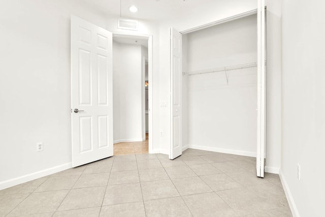1246 Via De Fossi, Boynton Beach, FL 33426 - unfurnished bedroom featuring light tile patterned floors, a closet, baseboards, and recessed lighting