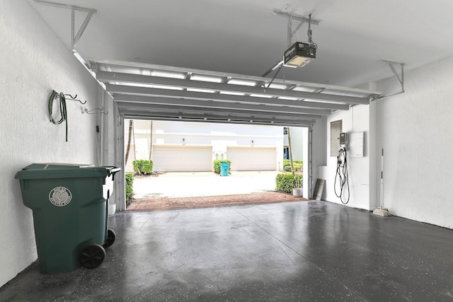 1246 Via De Fossi, Boynton Beach, FL 33426 - garage featuring a garage door opener and a textured wall