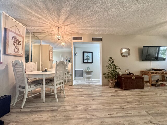 1560 NE 12th Ter Unit D9, Jensen Beach, FL 34957 - dining room with a textured ceiling and wood finished floors