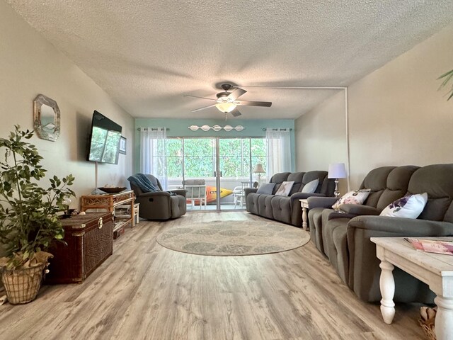 1560 NE 12th Ter Unit D9, Jensen Beach, FL 34957 - living area with wood finished floors, a textured ceiling, and a ceiling fan