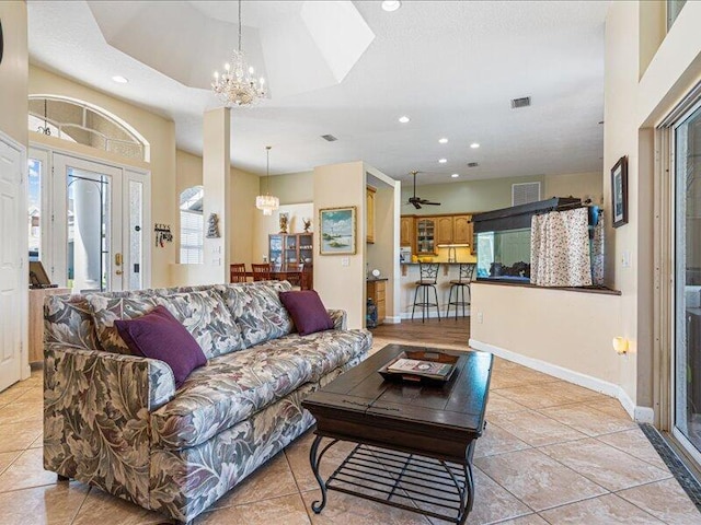 6575 NW Pomona Ct, Port Saint Lucie, FL 34983 - living room with a chandelier, recessed lighting, light tile patterned flooring, and a ceiling fan