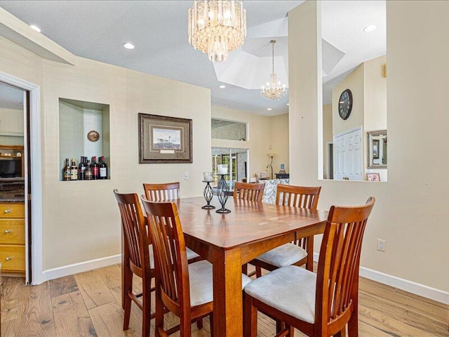 6575 NW Pomona Ct, Port Saint Lucie, FL 34983 - dining room with light wood finished floors, a chandelier, and recessed lighting