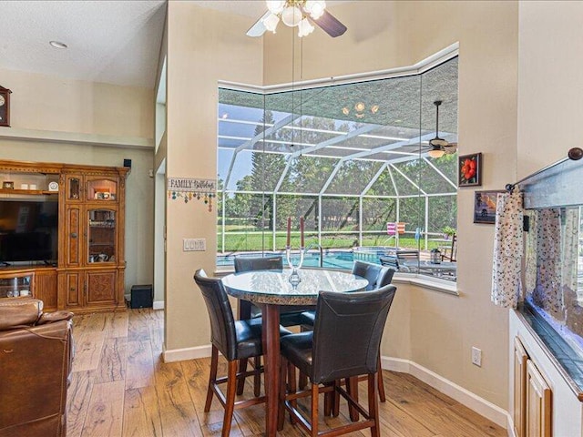 6575 NW Pomona Ct, Port Saint Lucie, FL 34983 - dining room featuring a sunroom, ceiling fan, and wood-type flooring