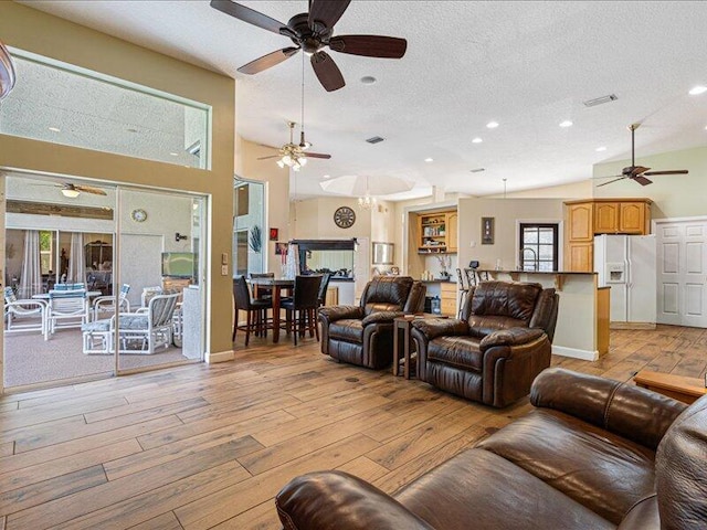 6575 NW Pomona Ct, Port Saint Lucie, FL 34983 - living room with ceiling fan, a textured ceiling, light wood-style floors, and recessed lighting