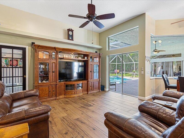 6575 NW Pomona Ct, Port Saint Lucie, FL 34983 - living area with ceiling fan, wood-type flooring, a textured ceiling, and a sunroom