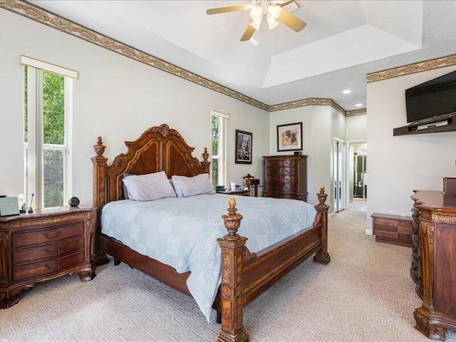 6575 NW Pomona Ct, Port Saint Lucie, FL 34983 - bedroom with light colored carpet, a raised ceiling, ornamental molding, and a ceiling fan