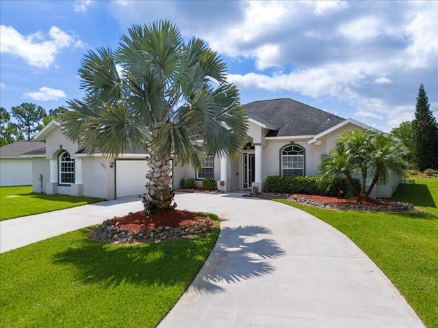 6575 NW Pomona Ct, Port Saint Lucie, FL 34983 - ranch-style home featuring curved driveway, an attached garage, stucco siding, and a front yard