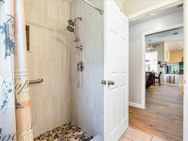 6575 NW Pomona Ct, Port Saint Lucie, FL 34983 - bathroom with a tile shower, ceiling fan, and wood finished floors