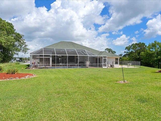 6575 NW Pomona Ct, Port Saint Lucie, FL 34983 - rear view of property with a lawn and glass enclosure