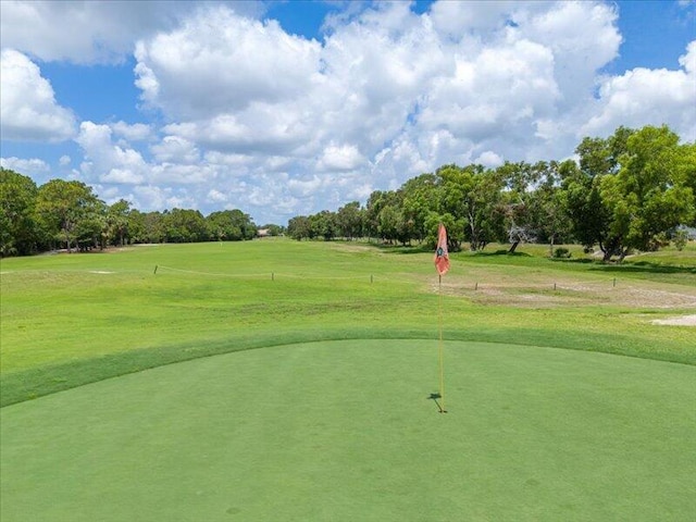 6575 NW Pomona Ct, Port Saint Lucie, FL 34983 - view of home's community with view of scattered trees, golf course view, a lawn, and a putting green