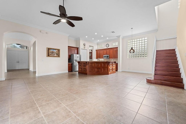 11218 Osprey Lake Ln, Palm Beach Gardens, FL 33412 - unfurnished living room with light tile patterned flooring, a ceiling fan, crown molding, stairway, and arched walkways