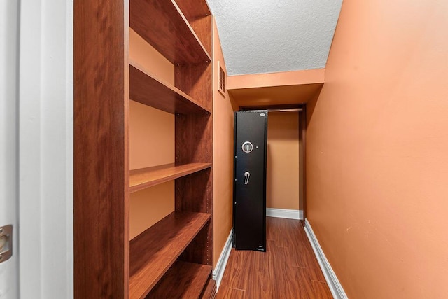 11218 Osprey Lake Ln, Palm Beach Gardens, FL 33412 - walk in closet with dark wood-style flooring