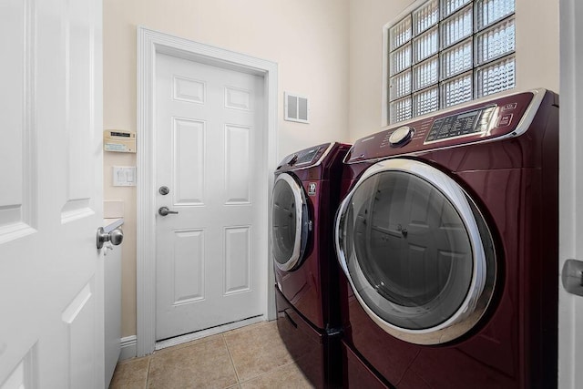 11218 Osprey Lake Ln, Palm Beach Gardens, FL 33412 - washroom featuring separate washer and dryer and light tile patterned floors