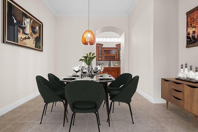 11218 Osprey Lake Ln, Palm Beach Gardens, FL 33412 - dining space with ornamental molding, light tile patterned flooring, and arched walkways