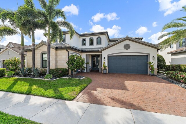 122 Cerulean Key Way, Jupiter, FL 33478 - mediterranean / spanish-style house featuring decorative driveway, a garage, stucco siding, and a front lawn
