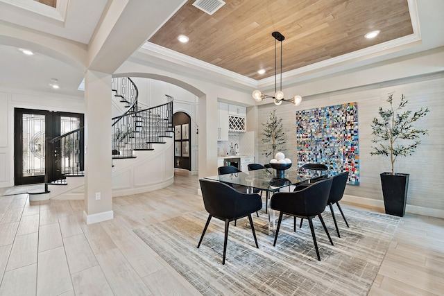 122 Cerulean Key Way, Jupiter, FL 33478 - dining area featuring a raised ceiling, arched walkways, stairs, light wood-style floors, and wooden ceiling