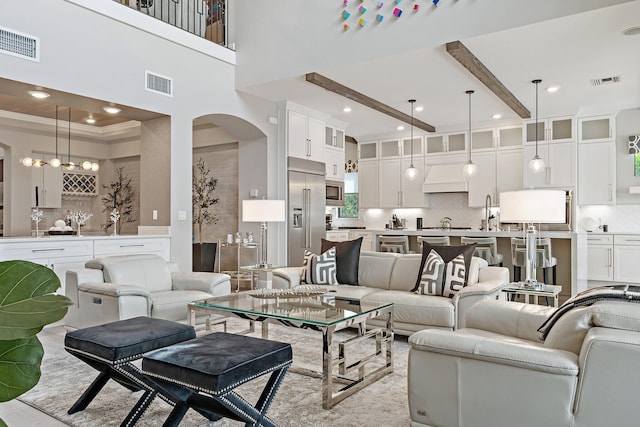 122 Cerulean Key Way, Jupiter, FL 33478 - living area with arched walkways, crown molding, and recessed lighting