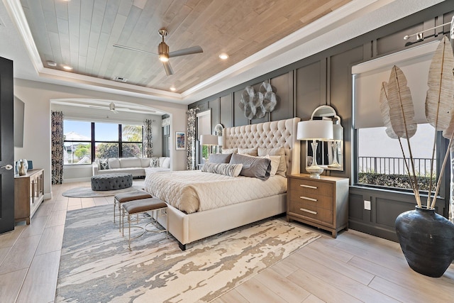 122 Cerulean Key Way, Jupiter, FL 33478 - bedroom with a tray ceiling, arched walkways, light wood-style floors, a ceiling fan, and recessed lighting