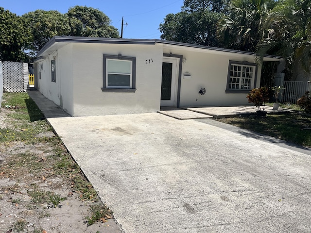 711 Fernwood Dr, West Palm Beach, FL 33405 - ranch-style house with stucco siding, a patio area, and fence