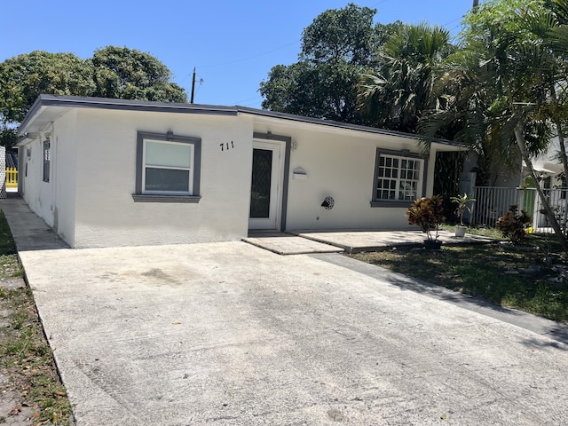 711 Fernwood Dr, West Palm Beach, FL 33405 - ranch-style home with stucco siding, a patio, and fence