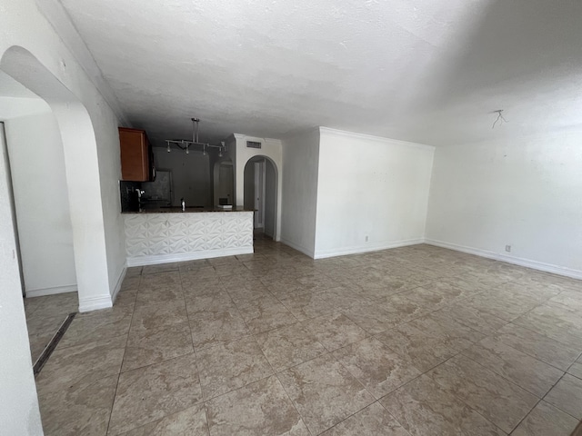 711 Fernwood Dr, West Palm Beach, FL 33405 - unfurnished living room featuring arched walkways and baseboards