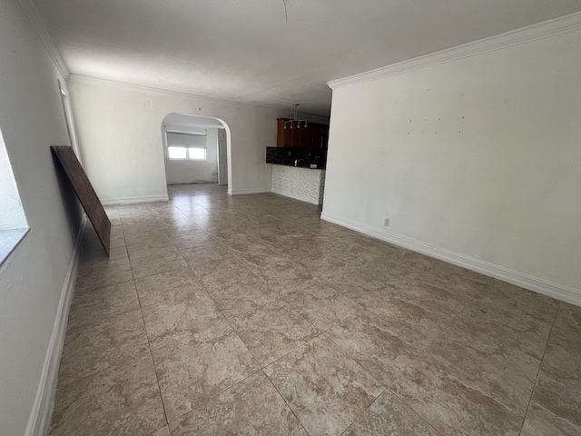 711 Fernwood Dr, West Palm Beach, FL 33405 - empty room featuring ornamental molding, arched walkways, and baseboards