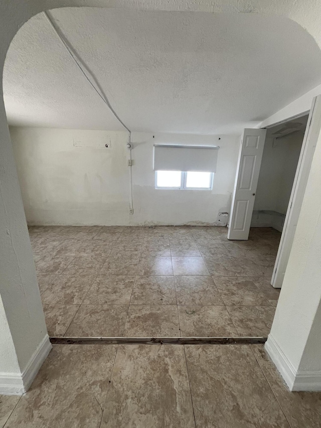 711 Fernwood Dr, West Palm Beach, FL 33405 - hall with a textured ceiling and baseboards