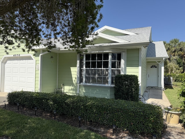 4050 Gator Trace Rd, Fort Pierce, FL 34982 - view of front facade with a shingled roof and an attached garage