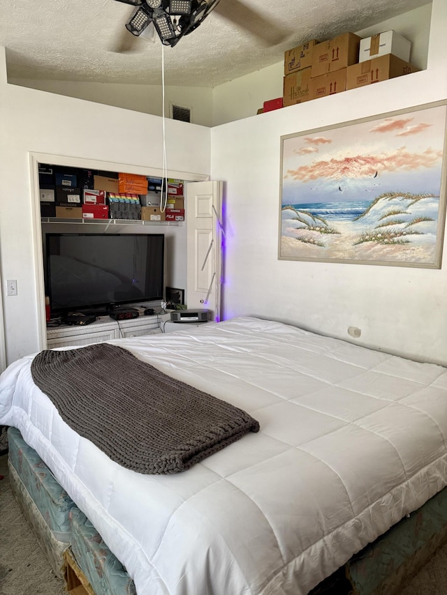 4050 Gator Trace Rd, Fort Pierce, FL 34982 - bedroom featuring a textured ceiling, carpet, and a ceiling fan