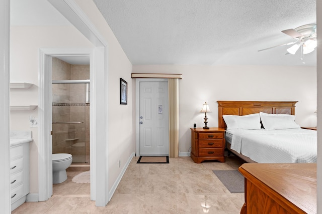 201 Bayview Ave Unit D, Boynton Beach, FL 33435 - bedroom with ensuite bath, baseboards, a textured ceiling, and light tile patterned floors
