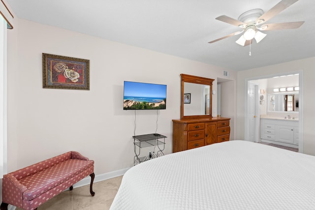 201 Bayview Ave Unit D, Boynton Beach, FL 33435 - bedroom featuring baseboards, a sink, ensuite bath, a ceiling fan, and light carpet