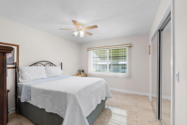 201 Bayview Ave Unit D, Boynton Beach, FL 33435 - bedroom featuring a closet, a textured ceiling, a ceiling fan, and baseboards