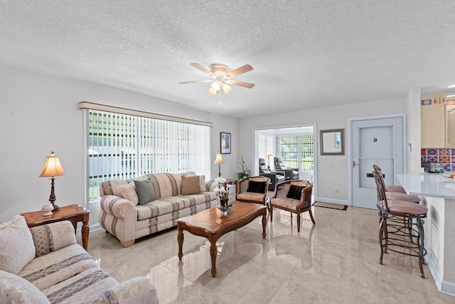 201 Bayview Ave Unit D, Boynton Beach, FL 33435 - living area with a ceiling fan, a textured ceiling, baseboards, and light marble finish floors