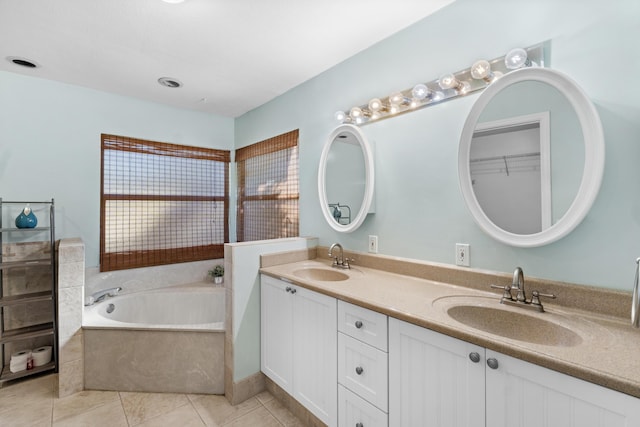 full bathroom featuring tile patterned flooring, a garden tub, and double vanity