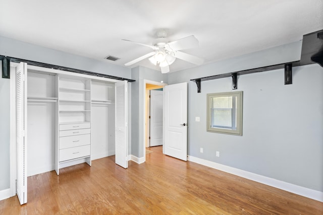 unfurnished bedroom featuring a closet, light wood-style floors, ceiling fan, and baseboards