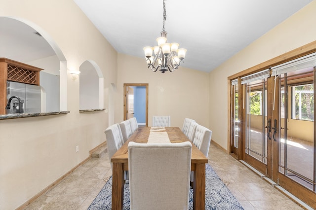 dining room featuring french doors, a chandelier, baseboards, arched walkways, and light tile patterned floors