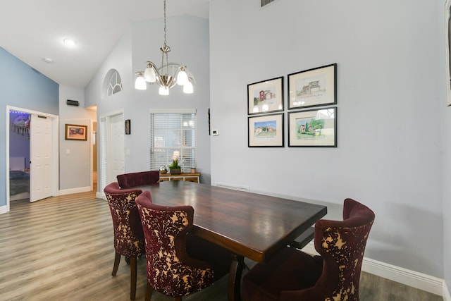 1644 Oak Berry Cir, Wellington, FL 33414 - dining area featuring a chandelier, high vaulted ceiling, light wood finished floors, and baseboards