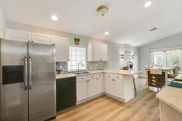 1644 Oak Berry Cir, Wellington, FL 33414 - kitchen featuring stainless steel fridge, black dishwasher, a sink, a peninsula, and light countertops