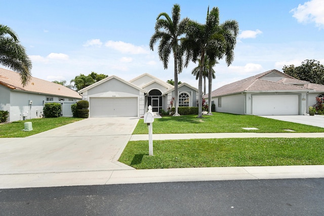 1644 Oak Berry Cir, Wellington, FL 33414 - ranch-style house featuring a garage, concrete driveway, a front yard, and stucco siding