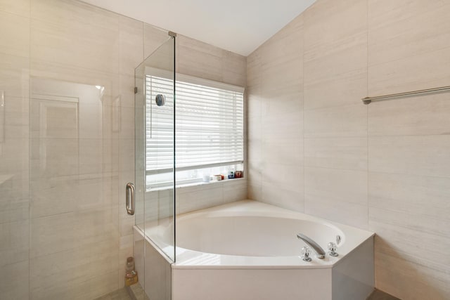 1644 Oak Berry Cir, Wellington, FL 33414 - bathroom with a stall shower, a bath, tile walls, and vaulted ceiling