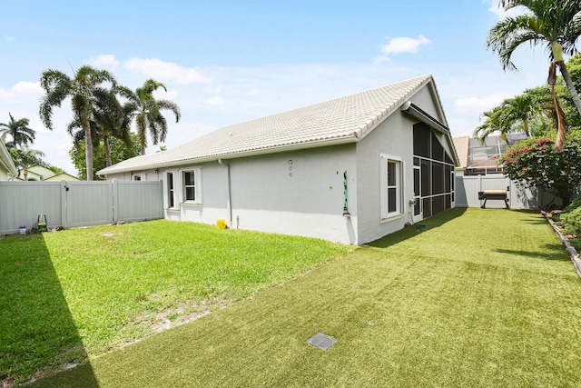 1644 Oak Berry Cir, Wellington, FL 33414 - back of property with a gate, stucco siding, a tile roof, and a sunroom