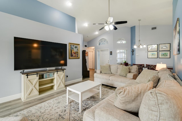 1644 Oak Berry Cir, Wellington, FL 33414 - living room featuring wood finished floors, a ceiling fan, a chandelier, baseboards, and high vaulted ceiling