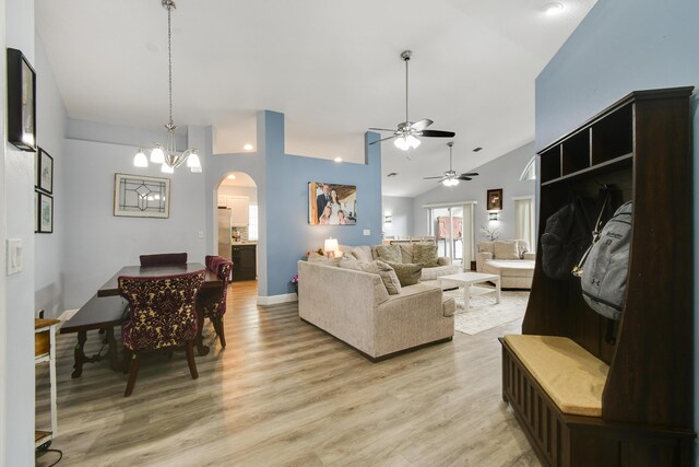 1644 Oak Berry Cir, Wellington, FL 33414 - living room with arched walkways, vaulted ceiling, ceiling fan, light wood-style floors, and a chandelier