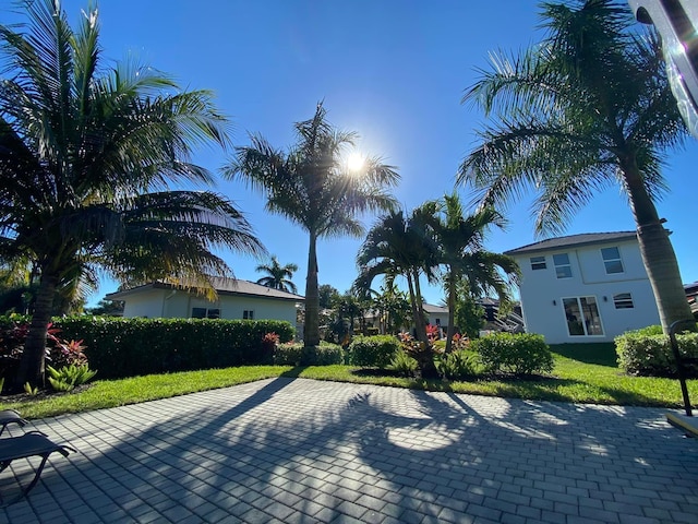 view of front facade featuring a front lawn and a patio area